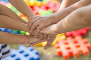 Children holding hands | 5 Supreme levels of Maslow's Hierarchy Theory and a Unique Approach by Krescon | krescon.com